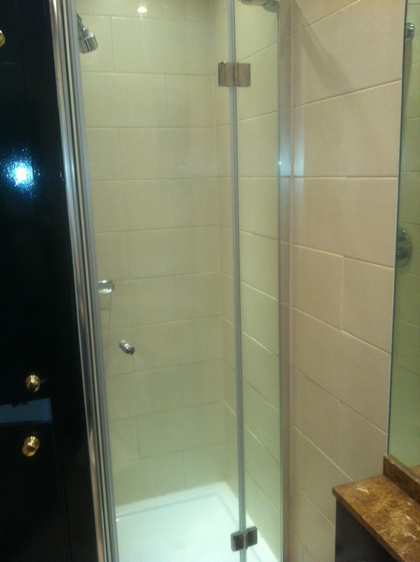 Frameless glass shower enclosure with chrome fittings in Walworth