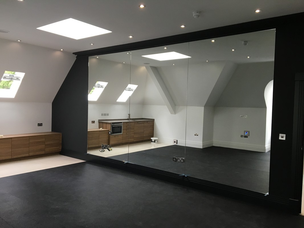 Frameless glass wall dividing loft conversion in Walworth