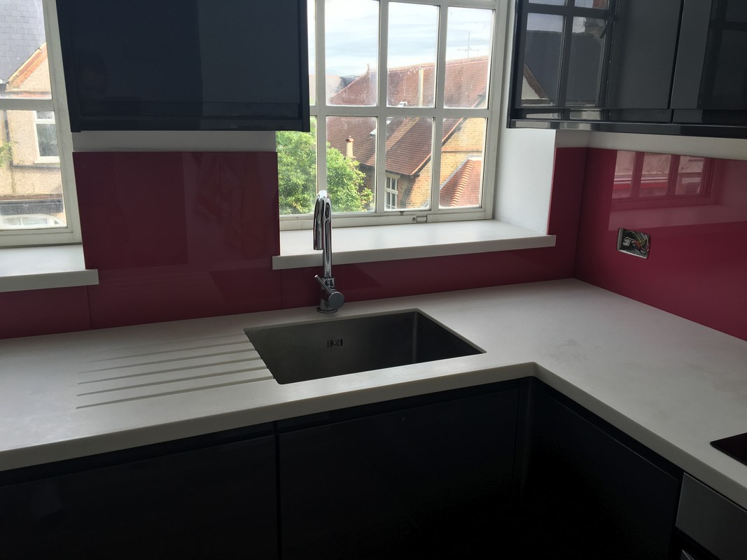 Deep plum coloured glass splashback in modern Walworth kitchen